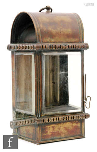 A 19th Century brass marine lantern of wedge form with bevelled glass side panels, fitted with a suspension loop and back slot fitment, height 40cm.