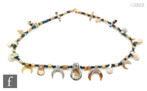 Roman 2nd to 4th Century AD - A string of iridescent and lunar drop beads with interspaced blue stones and central fantail pendant, length 43.5cm