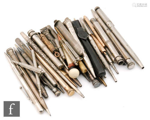 A silver cased ball point pen, five silver cased propelling pencils and others including a novelty negro example and various plated examples (qty)