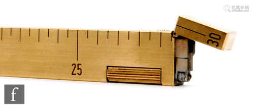 A later 20th Century Dunhill novelty foot rule gilt metal desk lighter, marked for inches and centimetres.