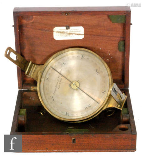 A 19th Century circular brass compass by Troughton & Simms London, mounted with folding sights and separate gimble attachment, width 20cm, in fitted mahogany case.