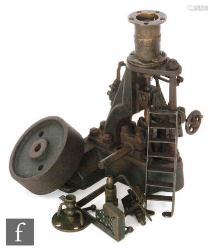 A 1930s cast iron steam engine with vertical oscillating piston, part disassembled, height 21cm