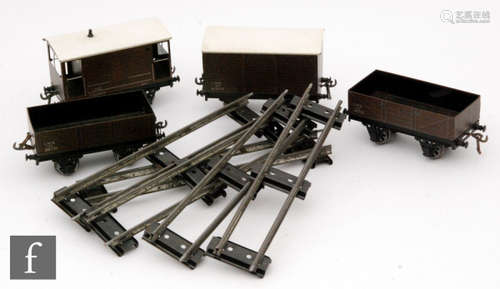 Four items of O gauge Bassett-Lowke rolling stock, all LMS, comprising two Open Wagons, a Covered Van and a Brake Van, all in partial boxes, with a selection of boxed track. (qty.)