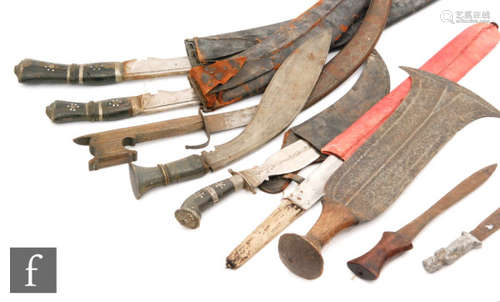 A large Kukri and scabbard and three other Kukris and Malaysian daggers (8)