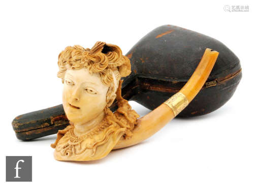 A large 19th Century carved meerschaum pipe in the form of a lady with plumed hair tied by a flowing vine and grapes, engraved gold band and amber stem A/F, cased and a briar Viking and horn stem pipe (2)