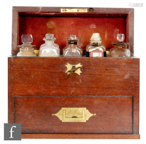 A 19th Century mahogany apothecary box, the case opening to reveal an arrangement of seven bottles and a measuring jug and a further drawer of bottles, width 25cm.