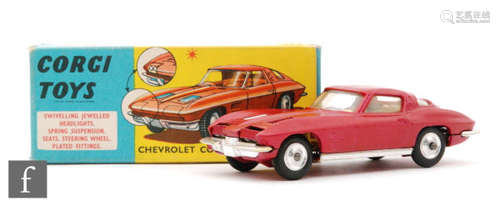 A Corgi Toys #310 Chevrolet Corvette Stingray diecast model in metallic cerise with yellow interior and spun hubs, in blue and yellow picture box with Corgi Model Club leaflet.