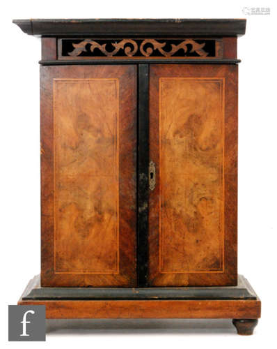 A musical wall mounted cabinet with coin the slot operating, later fitted shelf, interior enclosed by a pair of crossbanded doors, width 42cm (No movement)