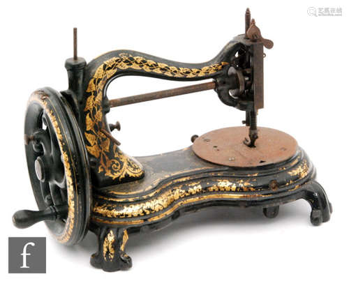 A 19th Century cast iron sewing machine with floral gilt leaf decoration on scroll base, No 4791, width 38cm