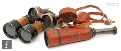 A pair of early 20th Century sporting binoculars, a similar pair by Dolland of London and a small World War One leather cased telescope, stamped Kelvin Hughes London 1917. (3)