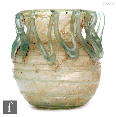 Roman 2nd to 4th Century AD - A pale blue glass bowl with ribbed body and applied lattice decoration, S/D, height 7.5cm