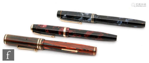 A Parker Duofold fountain pen with a 14ct gold N nib in purple marble effect case, another in dark blue and black effect and an Eversharp Flexible pen. (3)