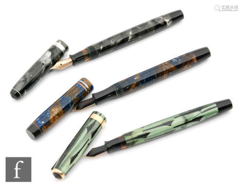 A Parker Challenger grey marble effect cased pen, a green Parker Duofold pen and another in blue and brown effect case. (3)