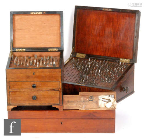 An early 20th Century mahogany two drawer chest fitted with steel dies, another similar with a side drawer and sloping front, a Brown & Sharp micrometer and a quantity of brass moulding tools (4)