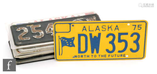 A collection of American and Canadian 1970s licence number plates to include Kentucky 74 H41-075, Yukon ACE 5 83, Alaska APW 975, Louisiana, North Carolina, five others and a pair of plates 25432 W15. (23)