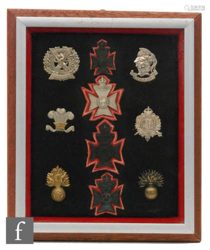 A group of ten military badges to include South Africa 1900/02, Scottish, London Rifle Brigade etc, 32cm x 27cm, framed