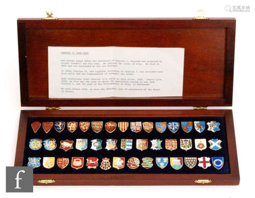 A cased set of forty two enamelled Heraldic emblems of the Kings and Queens of England with key to shields, cased (42)