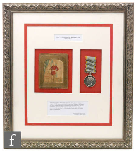 A Crimea medal awarded to Major E.A Whitmore, 30th foot regiment the ribbon mounted with three bars Sebastopol, Inkermann and Alma, framed and mounted with an internal photograph and footnote of his service, 45cm x 39cm, framed.