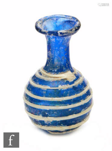 Roman 2nd to 4th Century AD - A miniature cobalt blue globular form flask decorated with white bee hive style bands, height 3.5cm