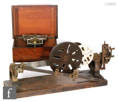 A woodworking lathe accessory, length 87cm and a separate cog wheel attachment in a mahogany case (2)