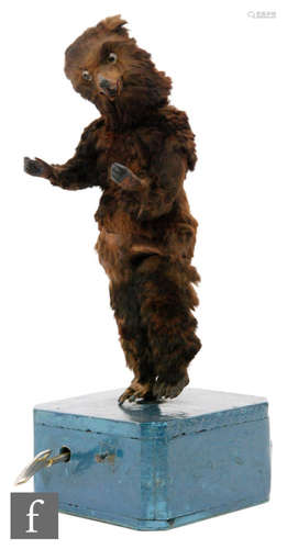 A 19th Century clockwork automaton of a brown dancing bear on later blue painted base, height 45cm