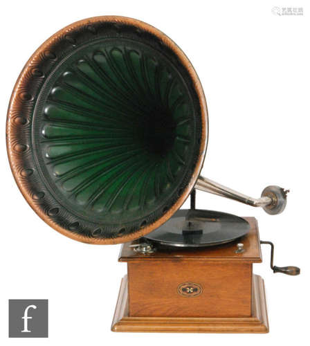 A 1920s Continental oak cased wind up gramophone with green tin horn on stepped plinth base, width 31cm