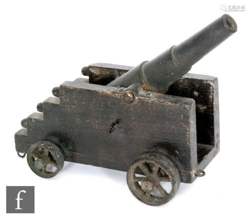 A late 19th to early 20th Century bronze Howitzer type canon on stepped wooden carriage and spoked wheels, length 24cm