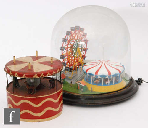 A 20th Century electric operated ferris wheel and carousel automaton in 19th Century glass dome, height 32cm and a part completed tinplate carousel with lead zoo animals, A/F (2)