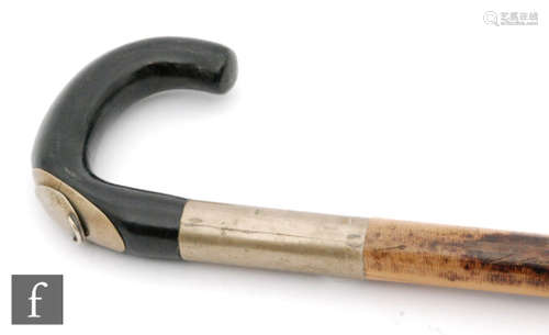 An early 20th Century bamboo walking stick, the ebonised top with pull out rule to measure horses hands incorporating a spirit level, length 93cm.