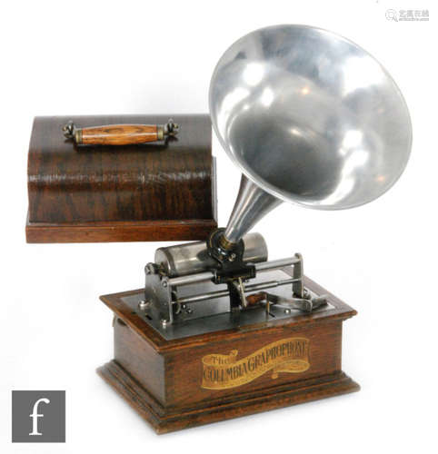 A Columbia Graphophone phonograph with reproducer and key wind operation, Leige retailer plaque and later aluminium horn, oak case and stepped plinth base, width 26cm