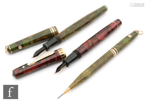 A Whal Eversharp fountain pen with 14ct gold nib and green marble effect pen with a matching propelling pencil and a similar Whal Eversharp model in purple case. (3)