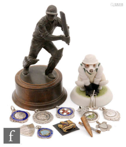 A 20th Century cold cast cricket figure of Peter Hicks batting, a novelty Jack Russell wicket keeper by Robert Harrop Designs and a small quantity of silver cricketing and other medals. (qty)