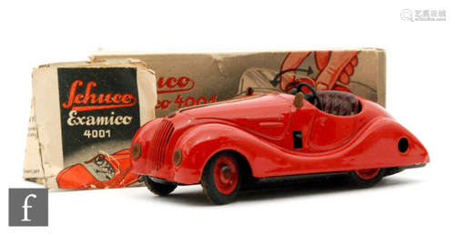 A Schuco Examico 4001 tinplate clockwork car in red with maroon seats, boxed with instructions, S/D.