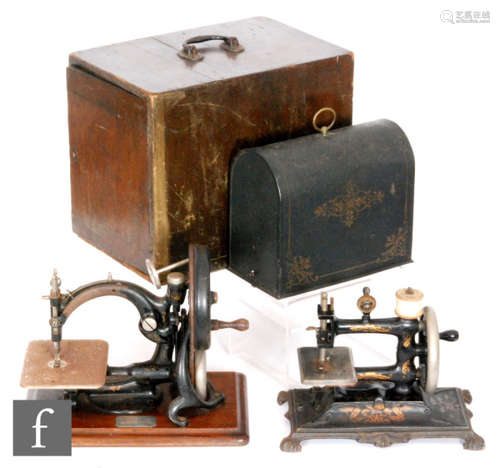 A late 19th Century Muller cast iron sewing machine No 60411 with painted tin dome case and a Wilcox and Gibbs sewing machine, the base mounted with silver presentation plaque inscribed and dated 1885, cased. (2)