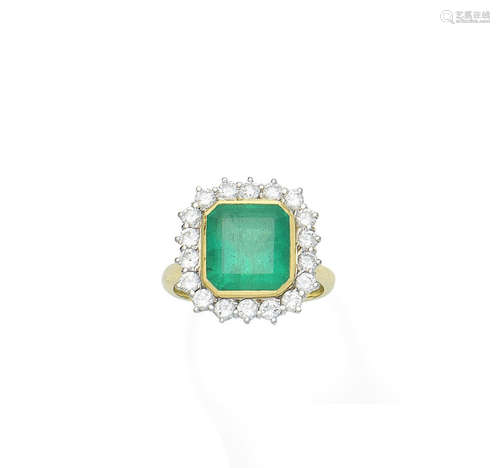 An emerald and diamond cluster ring