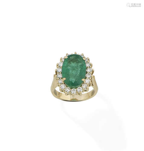 An emerald and diamond cluster ring