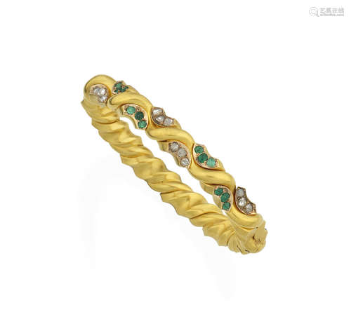 An emerald and diamond bangle