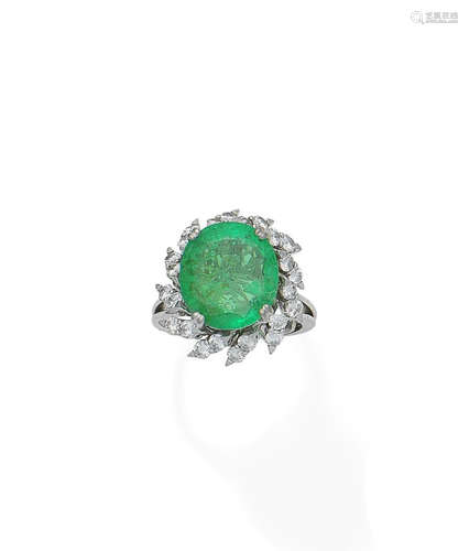 An emerald and diamond cluster ring