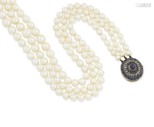 A cultured pearl necklace with a sapphire and diamond clasp