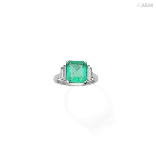 An emerald and diamond ring