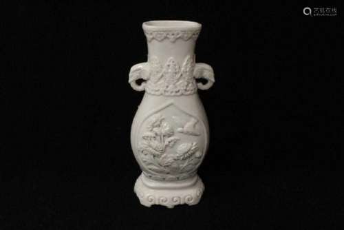 An Old vintage Chinese white porcelain vase in carved