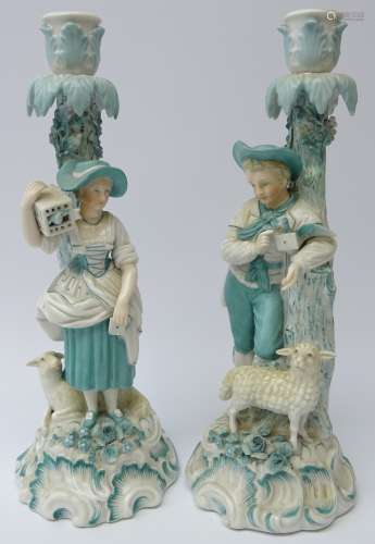 Pair 19th century porcelain candlesticks modelled as a male and female leaning against a tree
