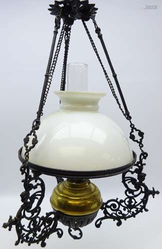 Black painted cast metal hanging oil lamp with pierced scroll mounts,