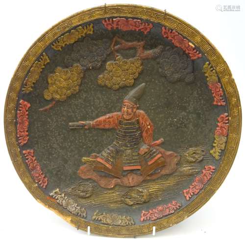 Japanese terracotta charger of circular form decorated in relief with a Samurai Warrior & cherry