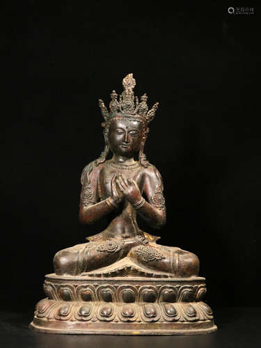 A COPPER BUDDHA ORNAMENT