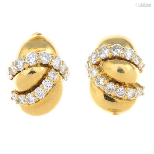 A pair of 18ct gold diamond earrings. Each designed as