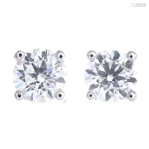 A pair of brilliant-cut diamond stud earrings. With