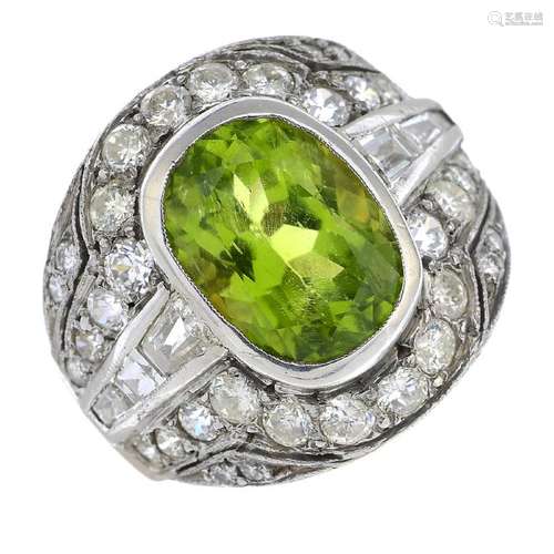 A 9ct gold and silver, peridot and diamond ring. The