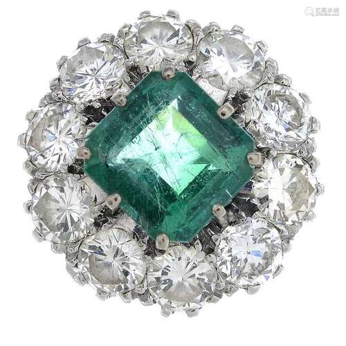 A mid 20th century platinum emerald and diamond cluster