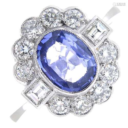 A sapphire and diamond cluster ring. The oval-shape